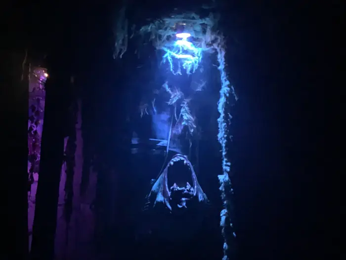 A dark creature display illuminated in blue light